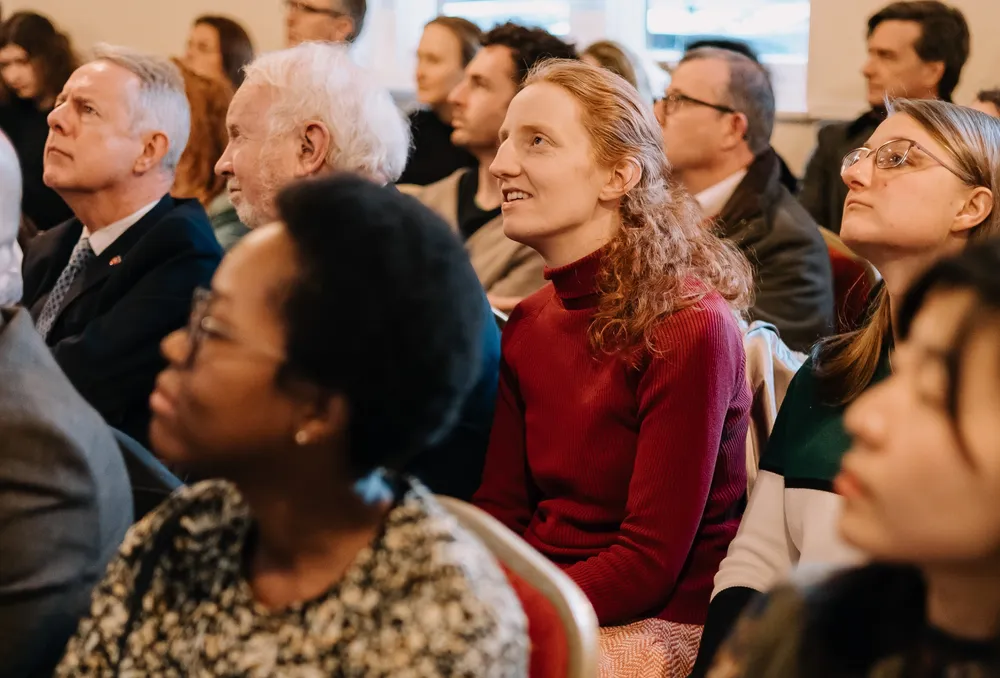 Faculty and graduate students filling Wycliffe Hall, listening intently during the book launch.