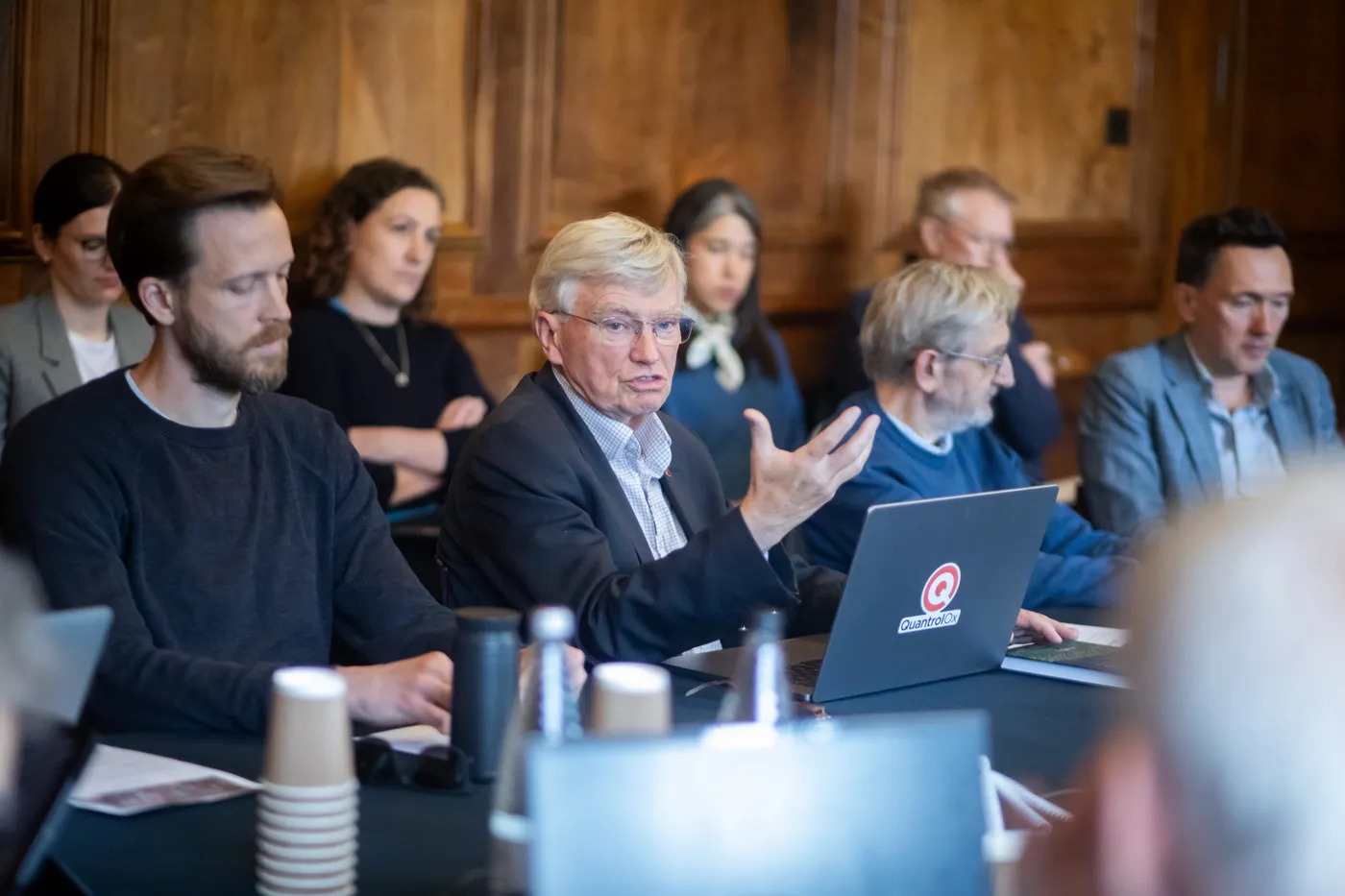 A senior academic making a point across the table during the Yarnton Manor retreat.
